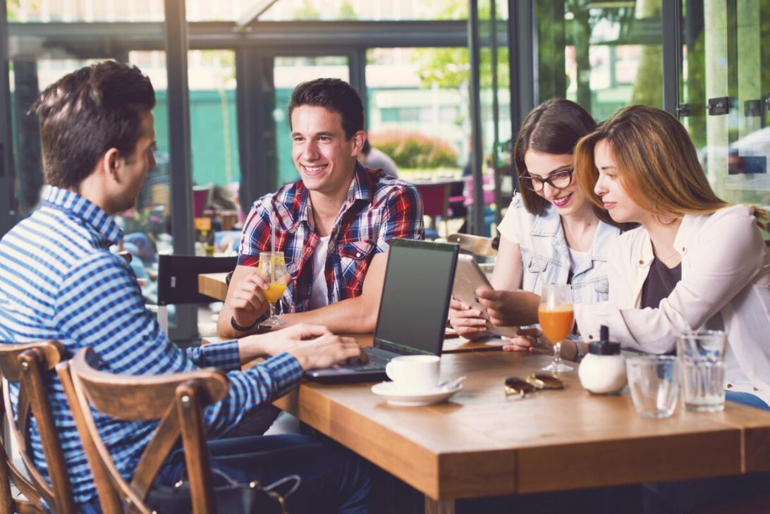 Personne notant des chiffres dans un carnet avec une calculatrice